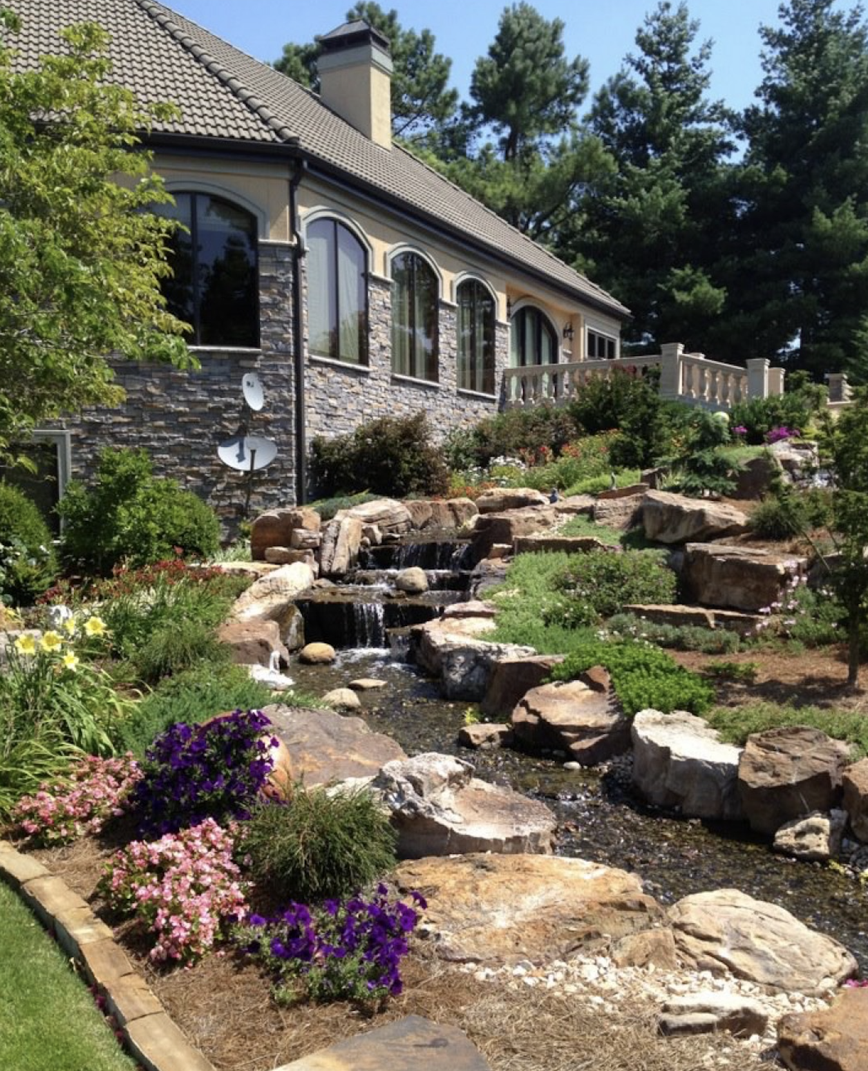 Hillside water feature and natural plantings